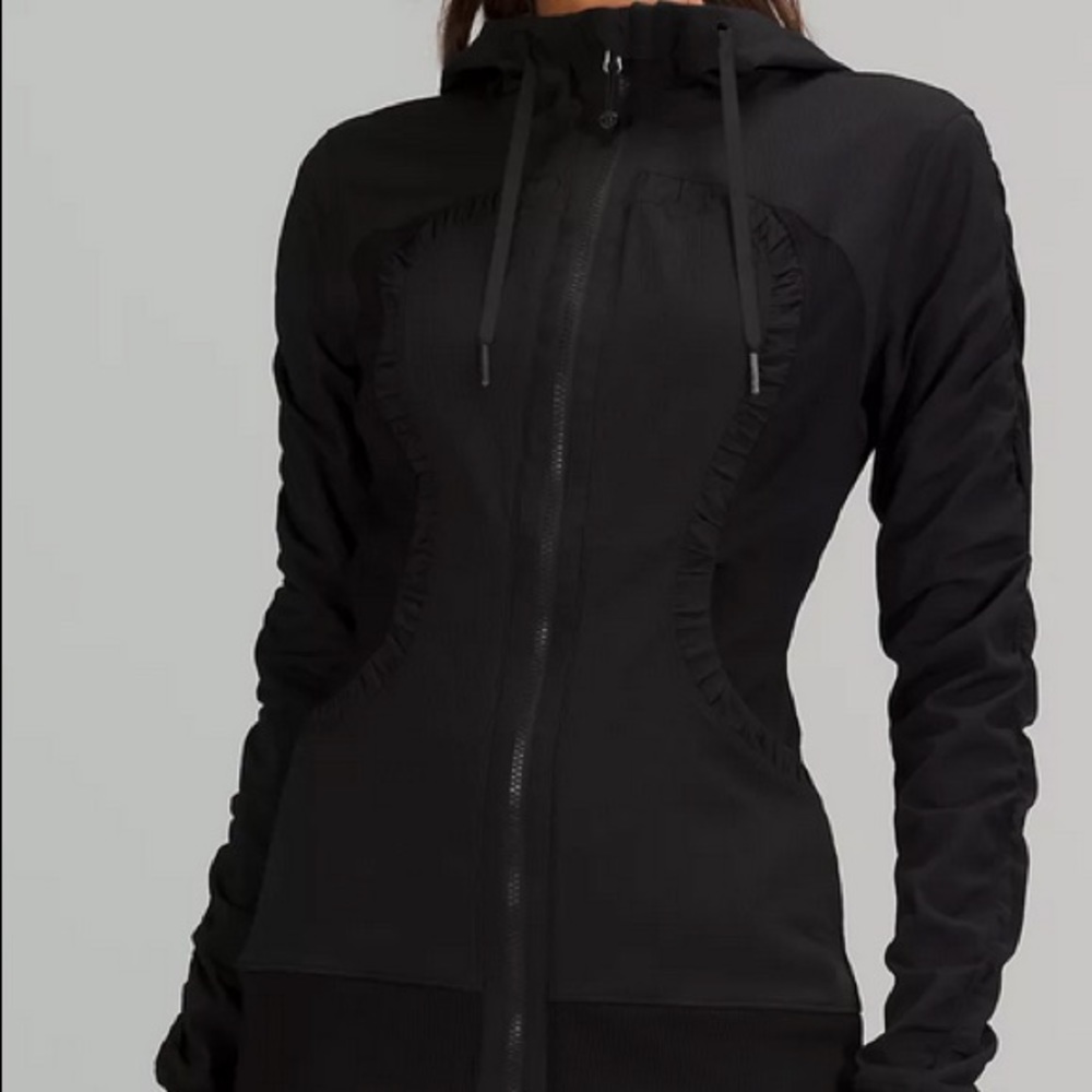 Lululemon workout jacket with hoodie.  Zipper front and over the hip style.
